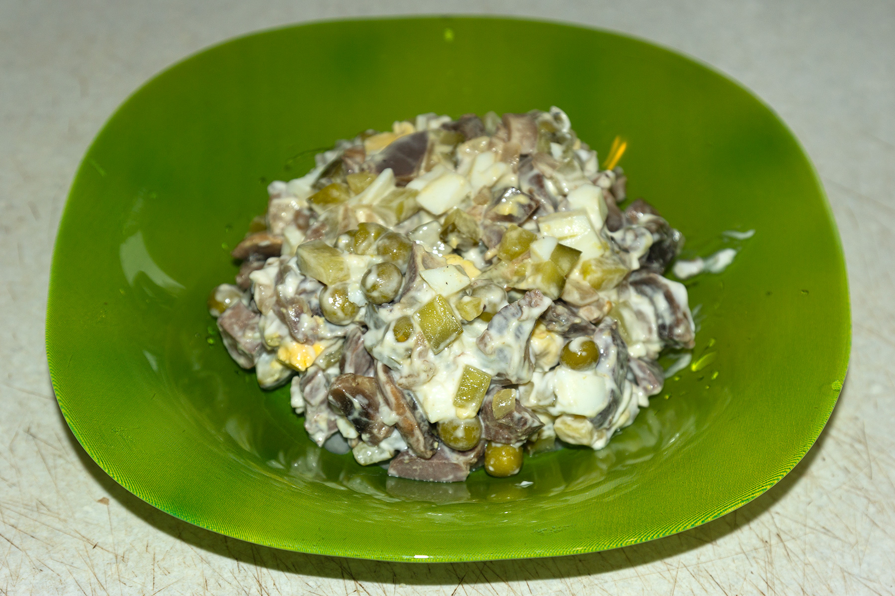 Фото к рецепту Салат "Пуп Земли" с куриными желудками Салат "Пуп Земли" с куриными желудками