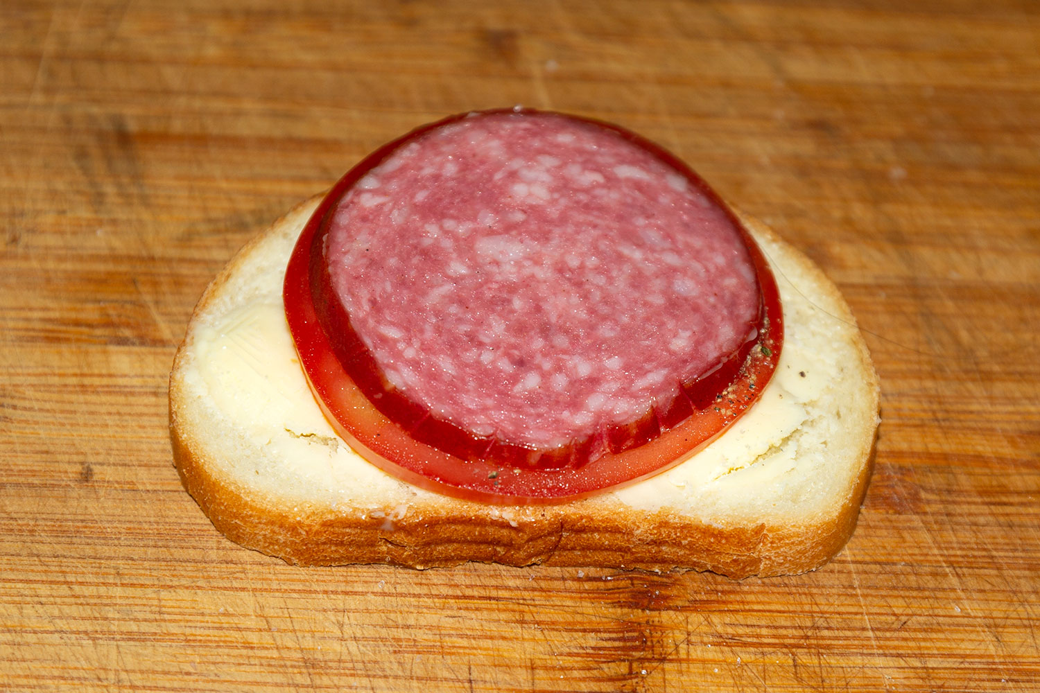 На батон уложить ломтики начинки для рецепта